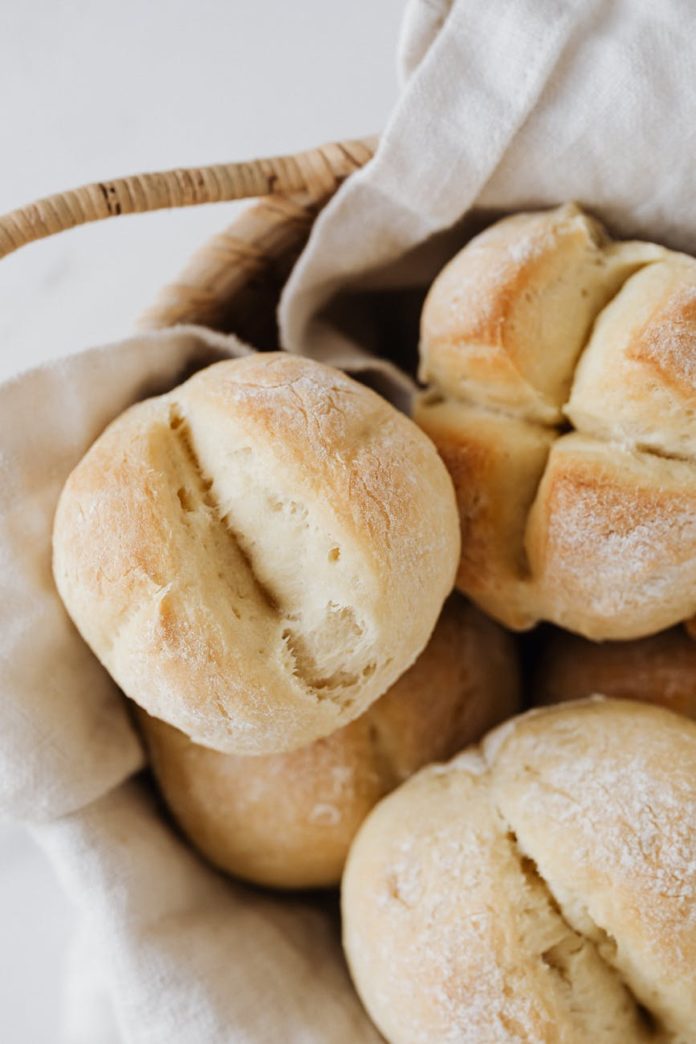 freshly baked white bread buns in a basket