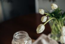 fresh ingredients and tulips in vase on kitchen table