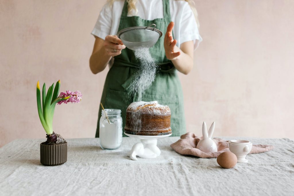 anonymous female serving cake with icing sugar
